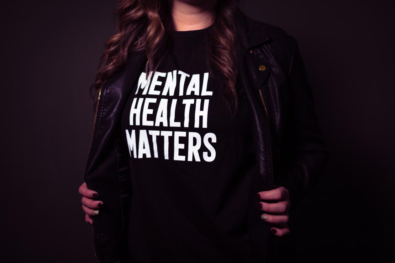Woman's torso with a shirt stating, "Mental health matters."